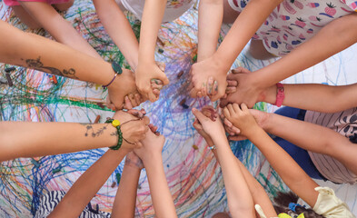 children holding hands over the picture they made