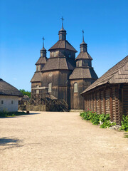 Wooden vintage church full height in Zaporozhian Sich medieval village, state of Cossacks on Khortytsia island, Ukraine.