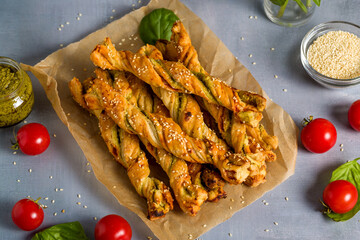 Bread sticks with sesame and tomato with pesto sauce