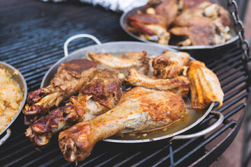 Food festival with food stall kiosk, open-air outdoor fair market, assortment of different traditional European grilled barbecued street food with sausages, bbq, chicken, pork and lamb on a large pan