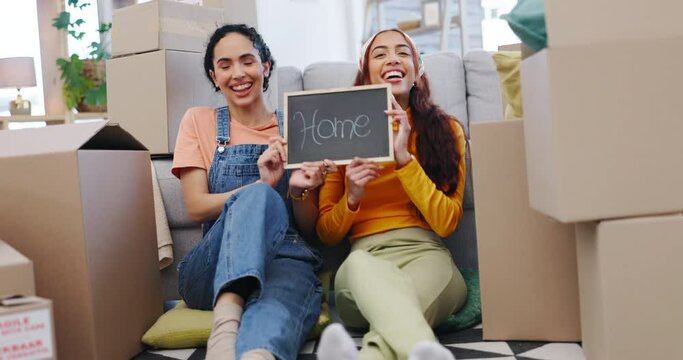 Happy, chalkboard and lesbian couple dancing in their new home together for growth or investment in property. Portrait, smile or moving house with a gay woman and lgbt partner in the living room