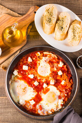 Shakshuka made of poached eggs in tomato pepper sauce