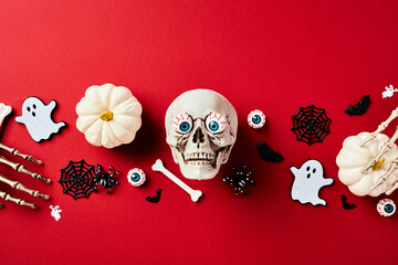 Happy Halloween holiday banner design. Flat lay composition with skull, pumpkins, monster hands,...