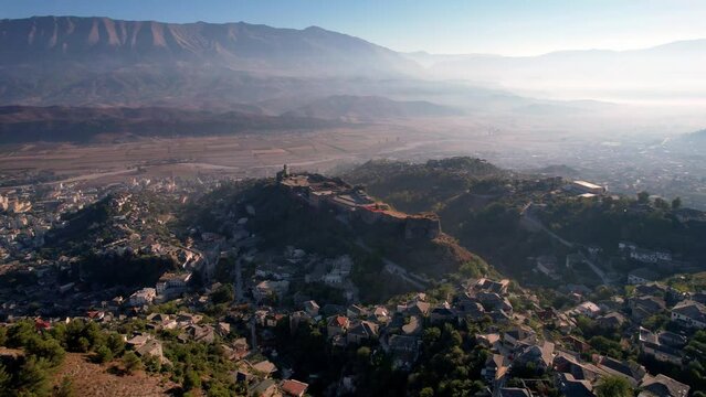 Aerial of Gjirokaster castle surrounded by amazing mountains.