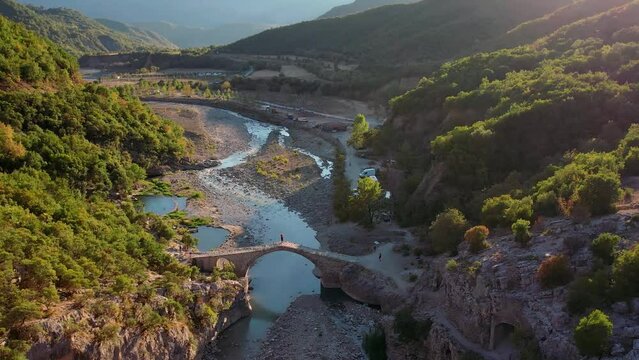 Aerial of sunset of bridge over river in Langarica Canyon in Albania.