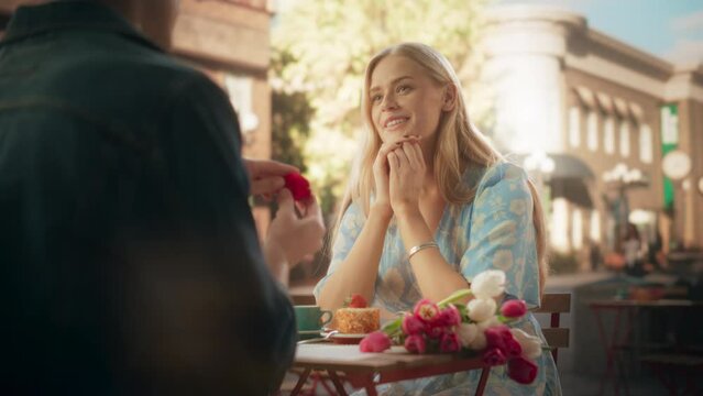 Marriage Proposal Concept. Fateful Boyfriend Gifts a Beautiful Shiny Wedding Ring to His Beautiful Blond Fiancee. Surprised Engaged Partner is Happy and Covers Her Face as She Gets Excited