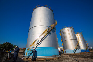 Male worker inspection visual storage tank oil