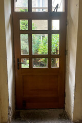 old door with glass to the street. House inside. Europe. an old house. front door interior