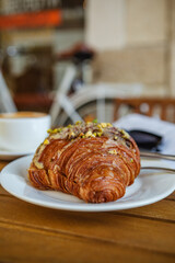 Breakfast time with croissant, coffee, and magazine