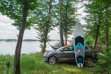 woman laying in hammock supboard on roof of car