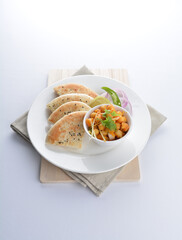 Indian vegetable bean curry sauce with baked naan pizza toast bread kebab breakfast on white background asian chef appetiser halal bakery food restaurant pastry menu for cafe