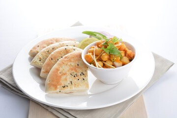 Indian vegetable bean curry sauce with baked naan pizza toast bread kebab breakfast on white background asian chef appetiser halal bakery food restaurant pastry menu for cafe
