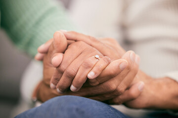 Couple holding hands for support, love and care of trust together in marriage relationship at home. Closeup of man, woman and helping hand of life partner with loyalty, commitment or hope for empathy