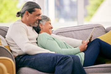 Obraz premium Tablet, mature couple and relax on sofa for streaming a funny, comedy show, movie or video together in lounge. Happy, man and woman in retirement with social media or mobile app for communication