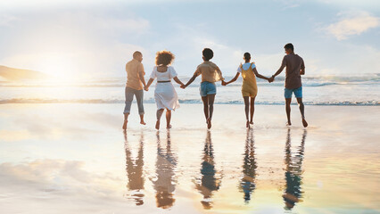Friends, together and holding hands on beach at sunset in summer, vacation or walking on holiday...