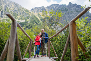 Fototapeta na wymiar Portrait of beautiful active senior couple hiking together in autumn mountains.
