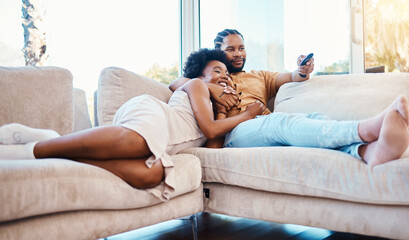 Couple, watching tv and relax on home sofa together with love, care and happiness. African man and woman in a living room with a remote control for streaming movies, show or series on a couch