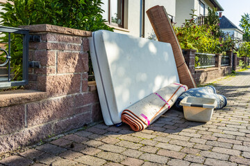 Bulk garbage day concept, miscellaneous rubbish items put on a street for council bulk waste...