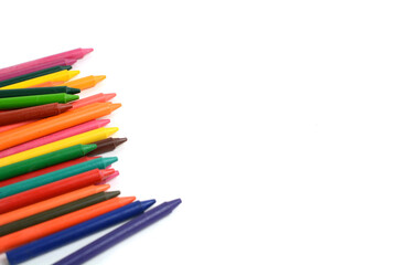 Crayons lined up isolated on white background.