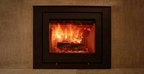 Energy fireplace on a wall, fire flames and burning wood logs in a stove