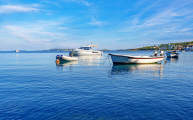 Fototapeta na wymiar Beach and boats on the Adriatic coast. Primosten, Croatia.