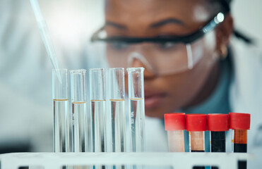 Science, blurred background and blood, woman with test tube in laboratory for research and medical...
