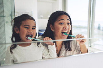 Mother, child and brushing teeth in dental hygiene, morning routine or healthcare together by...