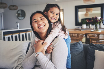 Hug, smile and portrait of mother and daughter on sofa for love, care and support. Happy, calm and relax with woman and young girl embrace in living room of family home for peace, cute and bonding