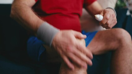 Man applying cream ointment on his knee, treatment for arthritis pain, injury