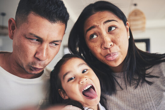 Selfie, Silly And Portrait Of Girl With Her Parents Bonding In The Living Room Of Their Home. Goofy, Happy And Child Taking A Picture With Her Mother And Father With Funny Faces At Their Family House