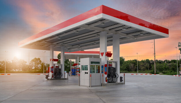 Gasoline pump nozzle sign. Fuel pump petrol station,Oil and Gas station at sunrise and orange sky .
