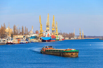 Barge sailing on the Oder river in Szczecin, Poland © olyasolod