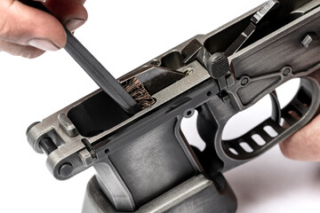 Man`s hands holding rifle parts details and cleaning the gun by metal brush