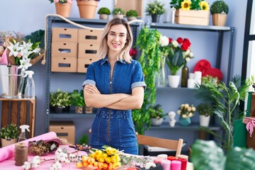 Young woman florist smiling confident standing with arms crossed gesture at florist