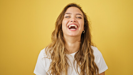 Young beautiful hispanic woman laughing a lot standing over isolated yellow background