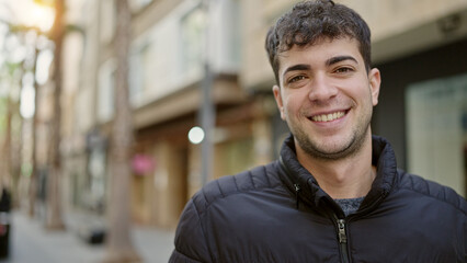 Young hispanic man smiling confident at street