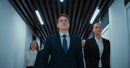 confident business team of charismatic boss walking in corridor of office center, 4K, Prores