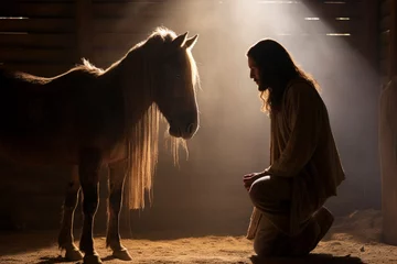 Fotobehang The silhouette of Jesus in a humble stable, resonating with the humility and compassion of his message  © Maksym