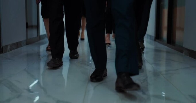 group of businesspeople walking in office building, closeup view of feet on floor, 4K, Prores