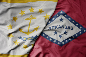 big waving colorful national flag of arkansas state and flag of rhode island state .