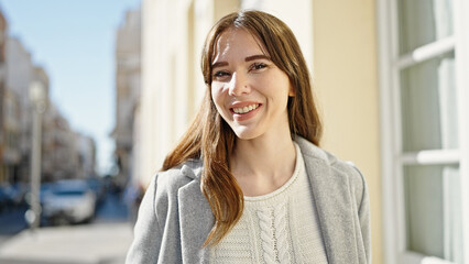 Fototapeta premium Young hispanic woman smiling confident at street
