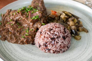 Gardiane de Taureau, gardianne, or daube camarguaise bull slow cooked stew served with rice from Camargue with vegetables, tastes of Camargue, Provence, France