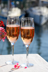 Summer party, drinking of French brut rose champagne sparkling wine in glasses in yacht harbour of Port Grimaud near Saint-Tropez, French Riviera vacation, France