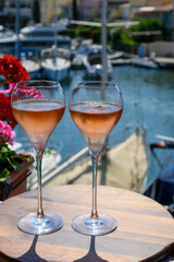 Summer party, drinking of French brut rose champagne sparkling wine in glasses in yacht harbour of Port Grimaud near Saint-Tropez, French Riviera vacation, France