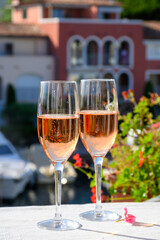 Summer party, drinking of French brut rose champagne sparkling wine in glasses in yacht harbour of Port Grimaud near Saint-Tropez, French Riviera vacation, France