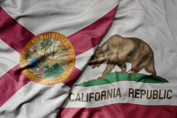 big waving colorful national flag of california state and flag of florida state .