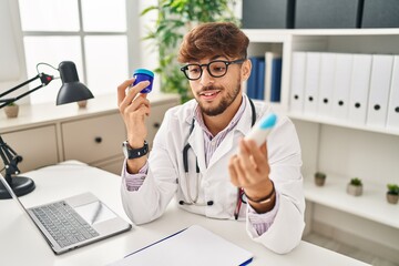 Young arab man wearing doctor uniform choosing respiratory treatment at clinic