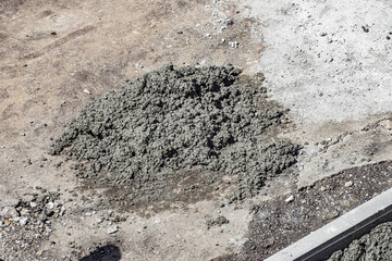 Road and sidewalk are full of holes. Road surface repair. Eliminate bumps and holes in road. Background. Top view of surrounding area.