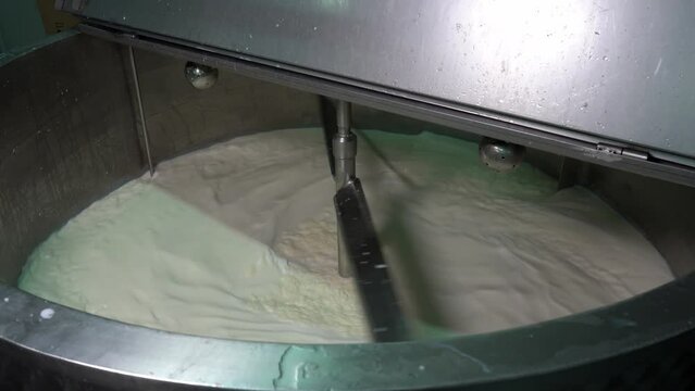Mixing Raw Milk in Pasteurization Tank. Pasteurization is a Process of Food Preservation in Which Milk is Treated with Mild Heat to Eliminate Pathogens. Dairy Plant Food Safety.