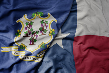 big waving colorful national flag of texas state and flag of connecticut state .